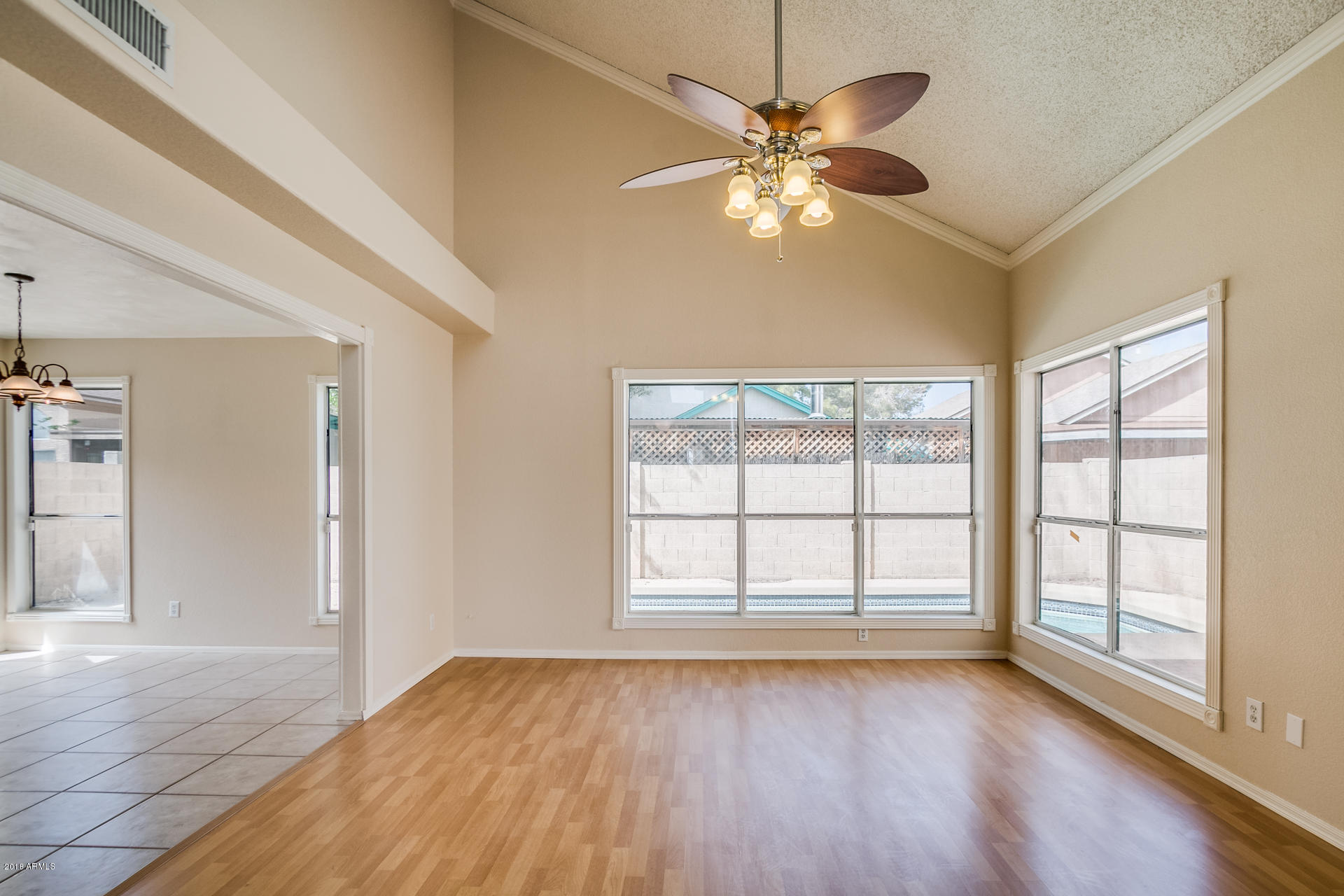 522 East Utopia Road Phoenix, AZ 85024 - Photo 15 of 35 a view of an empty room with wooden floor and a window