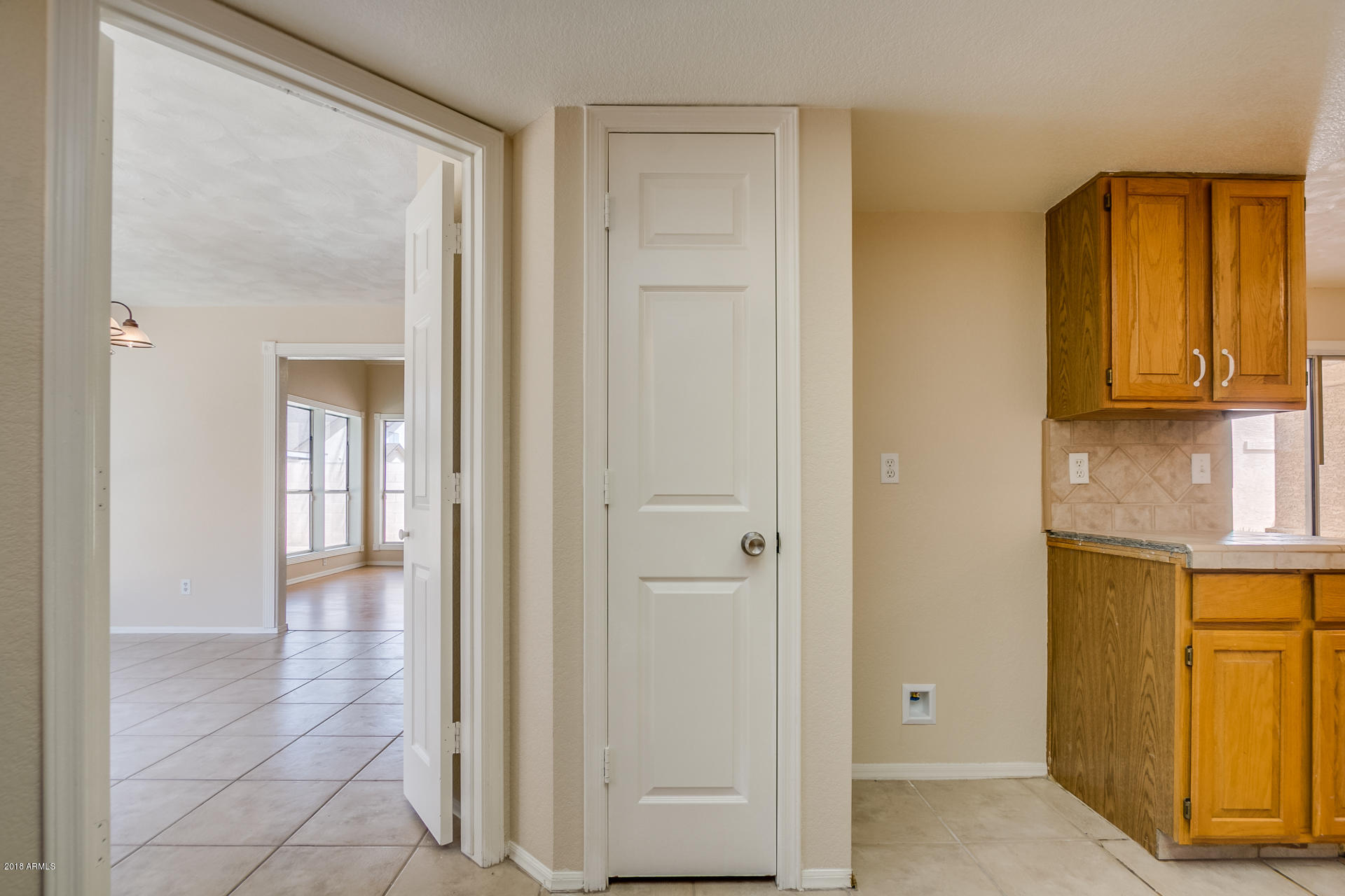 522 East Utopia Road Phoenix, AZ 85024 - Photo 8 of 35 a view of a hallway with wooden floor and cabinet