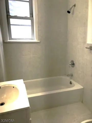 a white bath tub sitting next to a window