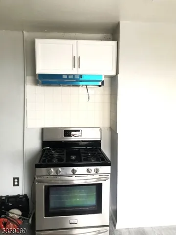 a close view of a stove a microwave and window
