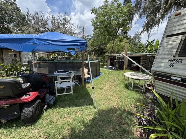 a view of a chairs and table in backyard