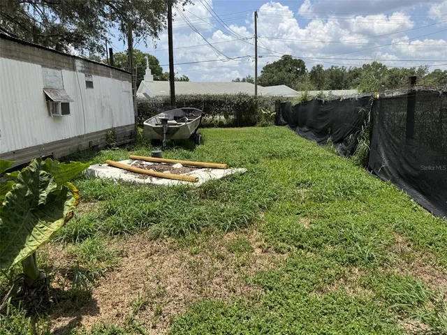 a view of a backyard with sitting area