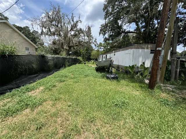 a backyard of a house with table and chairs