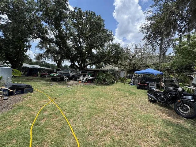a view of a yard with cars parked