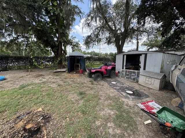 a backyard of a house with fire pit and outdoor seating
