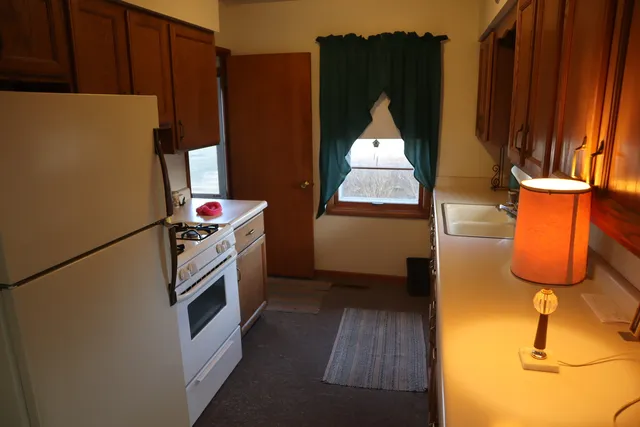 a kitchen with a refrigerator and a stove