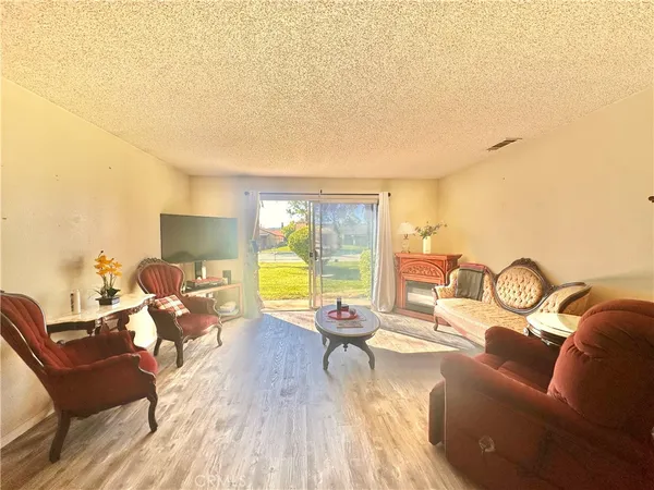 a living room with furniture floor to ceiling window and dining table