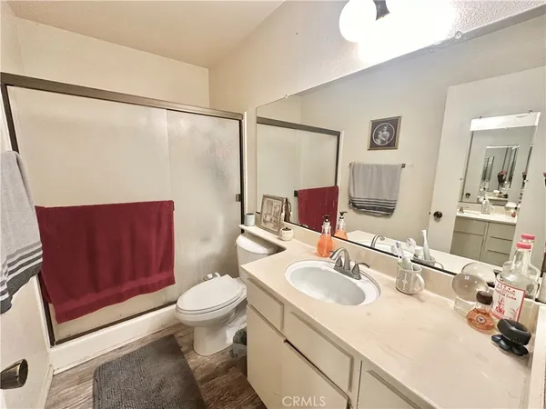 a bathroom with a sink toilet vanity and shower