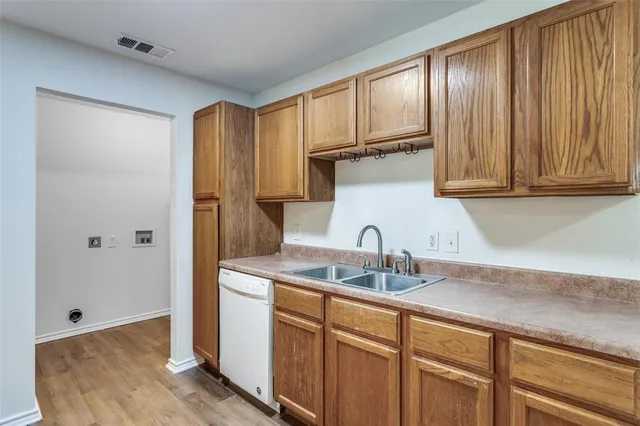 a kitchen with a sink cabinets and a window