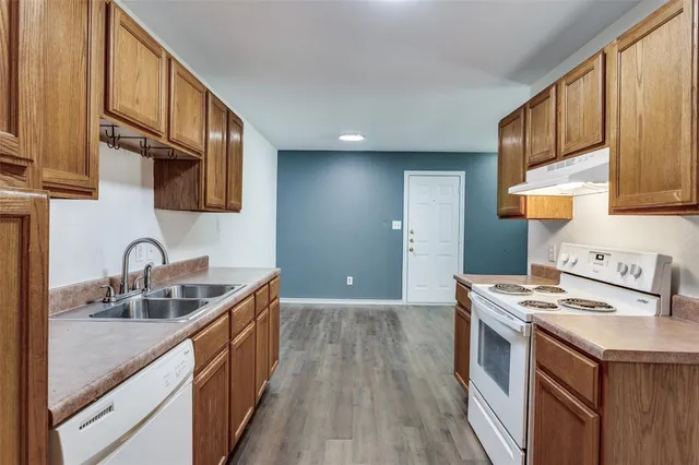 a kitchen with stainless steel appliances granite countertop a sink stove and cabinets