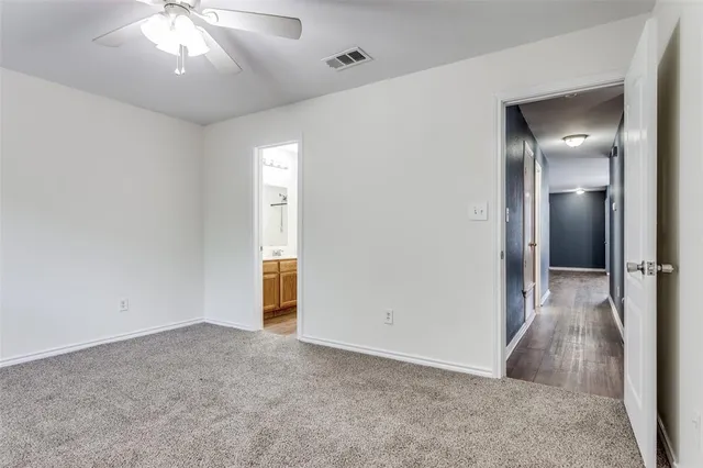 an empty room with closet and wooden floor