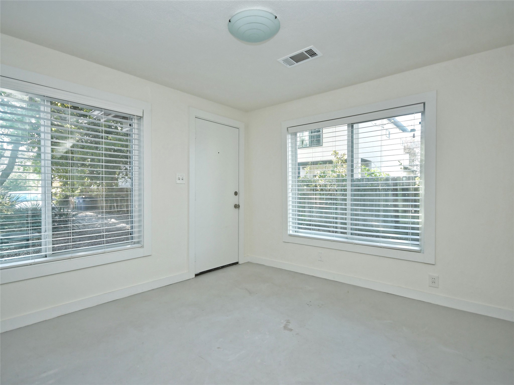 4604 Red River Street, Unit B Austin, TX 78751 - Photo 7 of 15 A versatile interior space featuring large windows that invite abundant natural light.