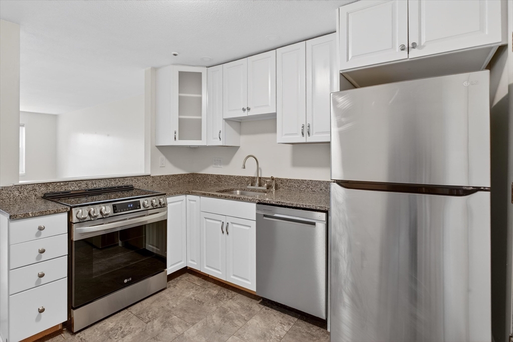 881 Main Street, Unit 9 Walpole, MA 02081 - Photo 1 of 25 a kitchen with granite countertop cabinets stainless steel appliances and a counter space