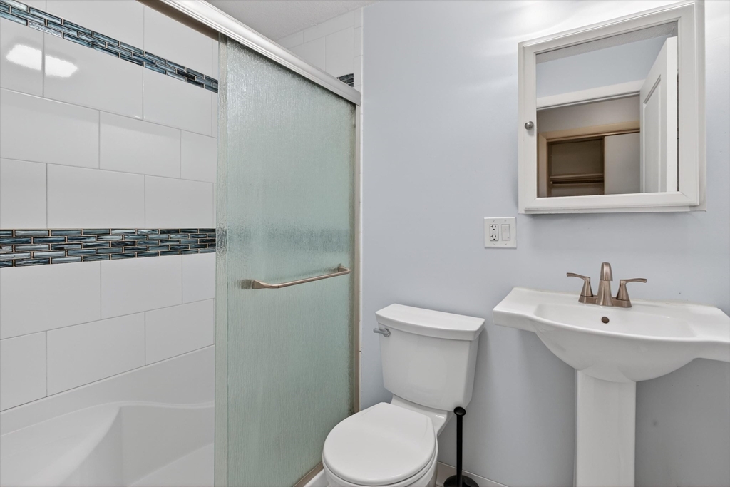 881 Main Street, Unit 9 Walpole, MA 02081 - Photo 7 of 25 a bathroom with a sink toilet and mirror