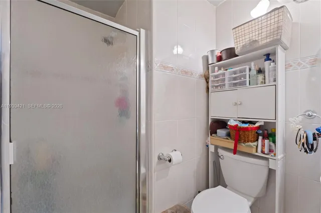 a white toilet sitting next to a bathroom sink