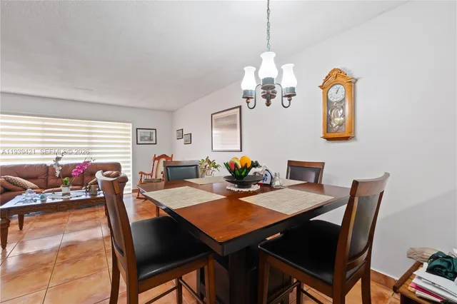 a view of a dining room with furniture wooden floor and chandelier
