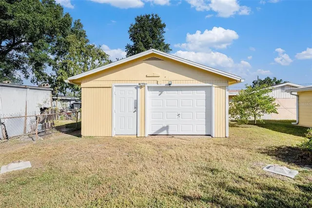 a view of a house with a yard and garage