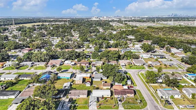 an aerial view of residential houses with outdoor space and river