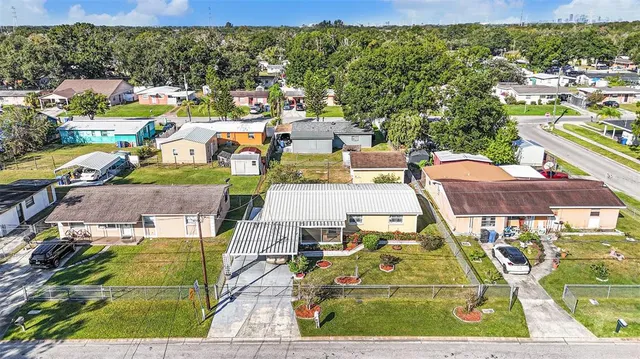 an aerial view of residential houses with outdoor space and street view