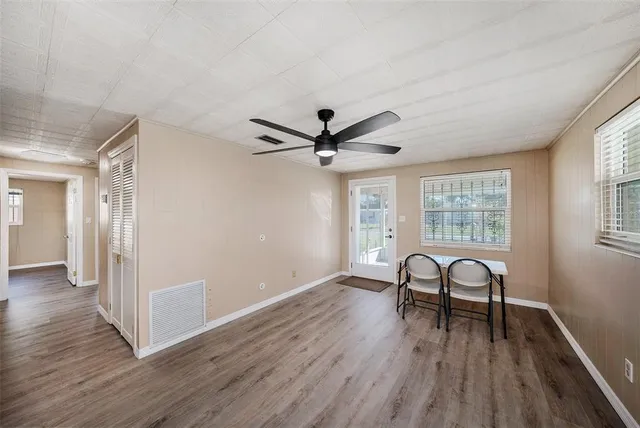 a view of a livingroom with furniture and hardwood floor