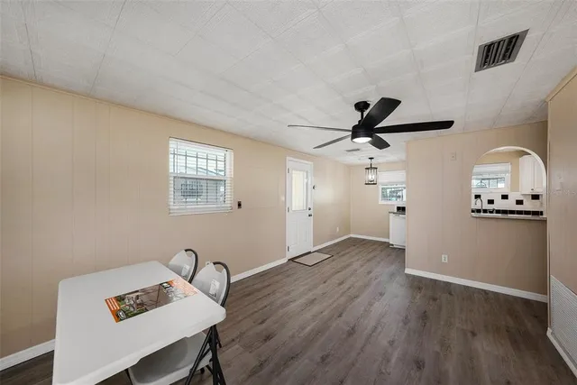 a view of a workspace with furniture and wooden floor