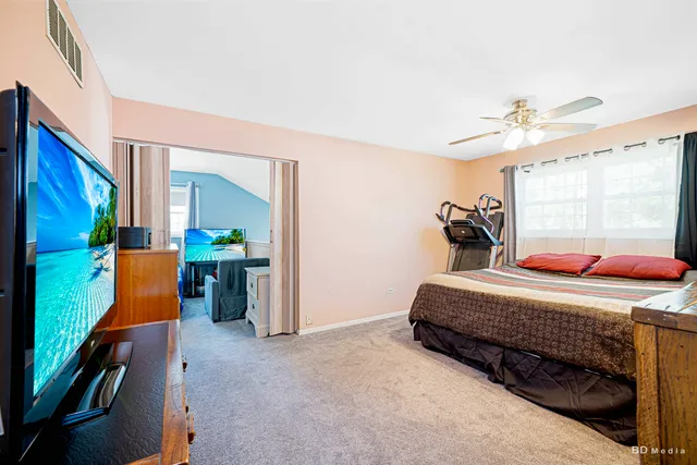 a bedroom with bed and window