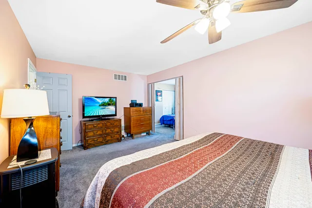 a bedroom with a bed and flat screen tv
