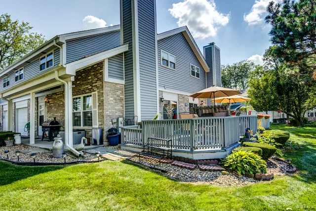 a view of a house with backyard and sitting area