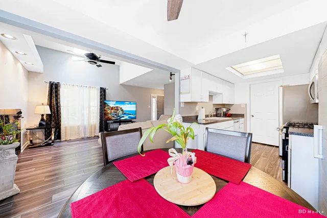 a living room with kitchen island furniture and a wooden floor