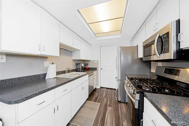 a kitchen with stainless steel appliances granite countertop a stove a sink dishwasher and a refrigerator