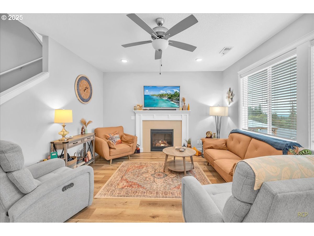 35560 Valley View Drive St. Helens, OR 97051 - Photo 16 of 47 a living room with furniture a fireplace and a large window