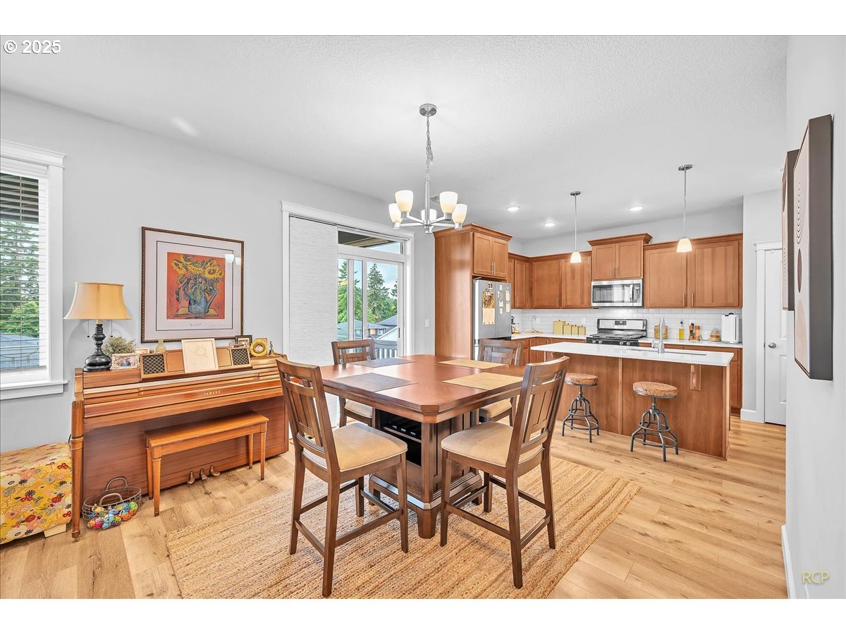 35560 Valley View Drive St. Helens, OR 97051 - Photo 18 of 47 a dining hall with stainless steel appliances kitchen island granite countertop a dining table chairs and a refrigerator