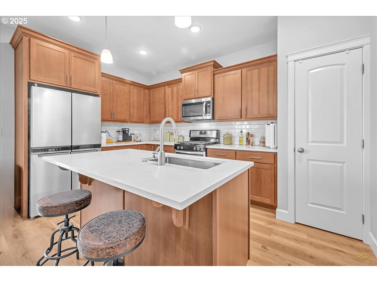 35560 Valley View Drive St. Helens, OR 97051 - Photo 21 of 47 a kitchen with kitchen island a sink table and chairs