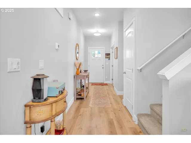 a view of entryway and hall with wooden floor