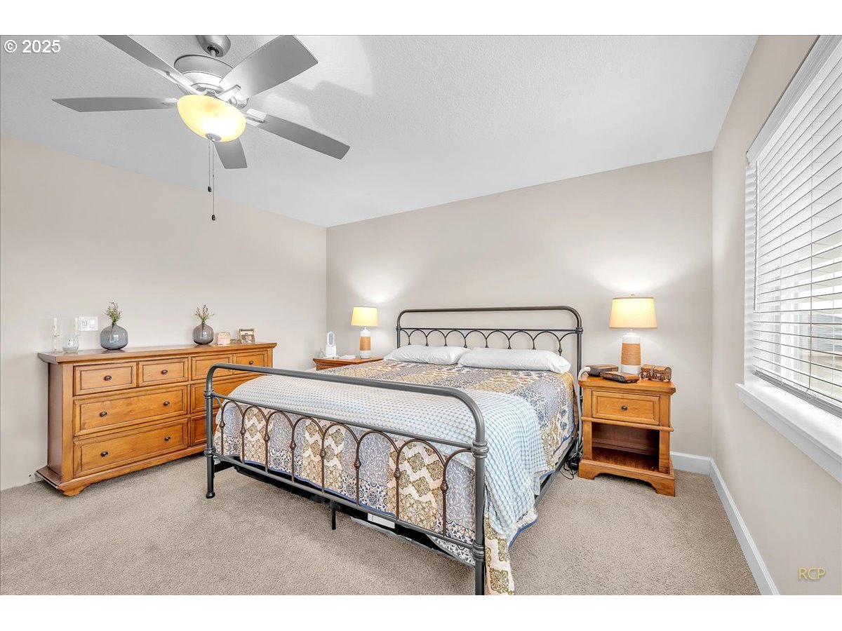 35560 Valley View Drive St. Helens, OR 97051 - Photo 28 of 47 a bedroom with a bed and a chandelier