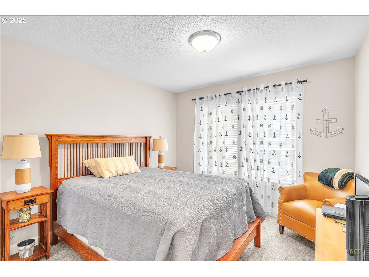 35560 Valley View Drive St. Helens, OR 97051 - Photo 32 of 47 a bedroom with a bed and a couch