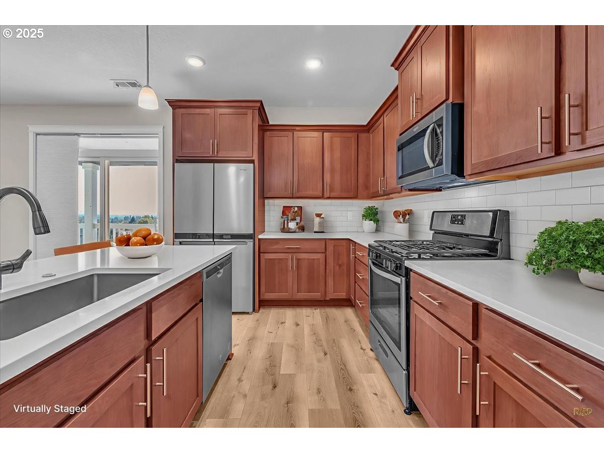 35560 Valley View Drive St. Helens, OR 97051 - Photo 43 of 47 a kitchen with granite countertop wooden cabinets stainless steel appliances a sink and a window