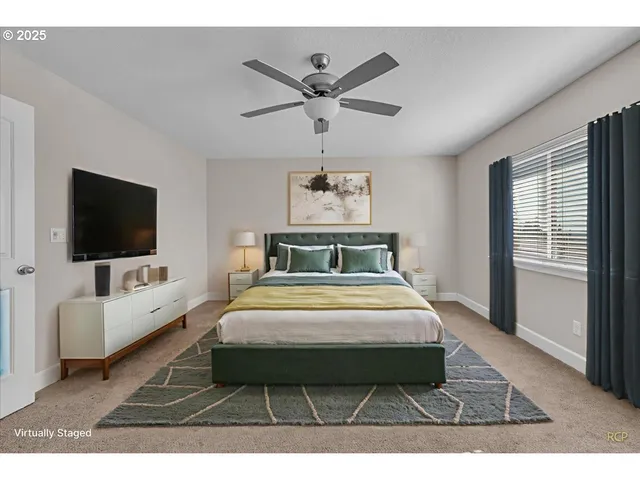 a bedroom with a large bed and a flat screen tv