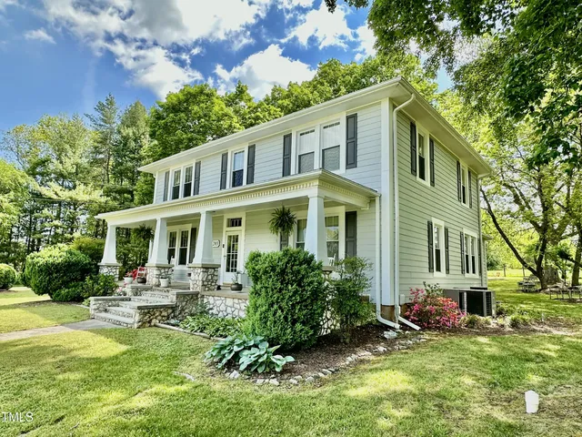 a front view of house with yard and green space