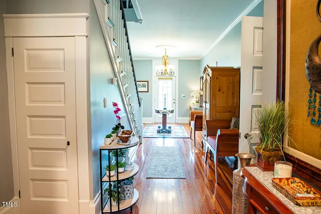 a bedroom with a bed a dresser and next to a window