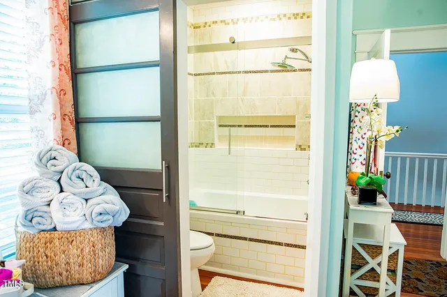 a front view of a house with a garden and trees