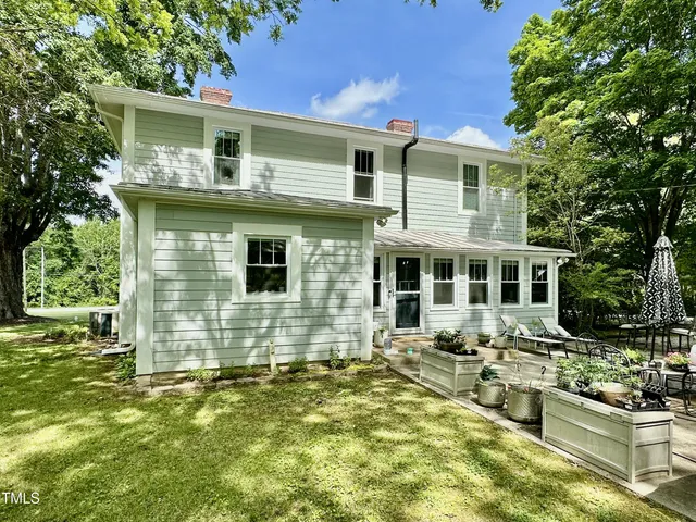 a view of a backyard with sitting area