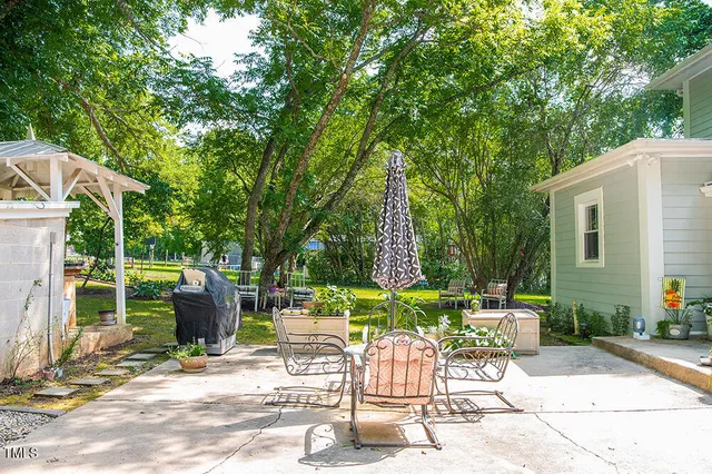 a view of a house with a yard patio and swimming pool