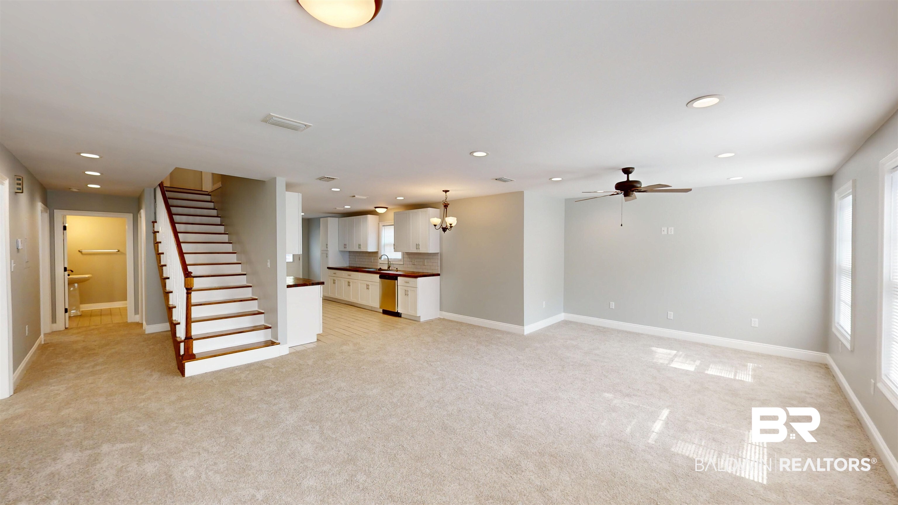 2454 Taylor Avenue Mobile, AL 36606 - Photo 5 of 24 Unfurnished living room featuring light carpet, suspended lighting, and ceiling fan