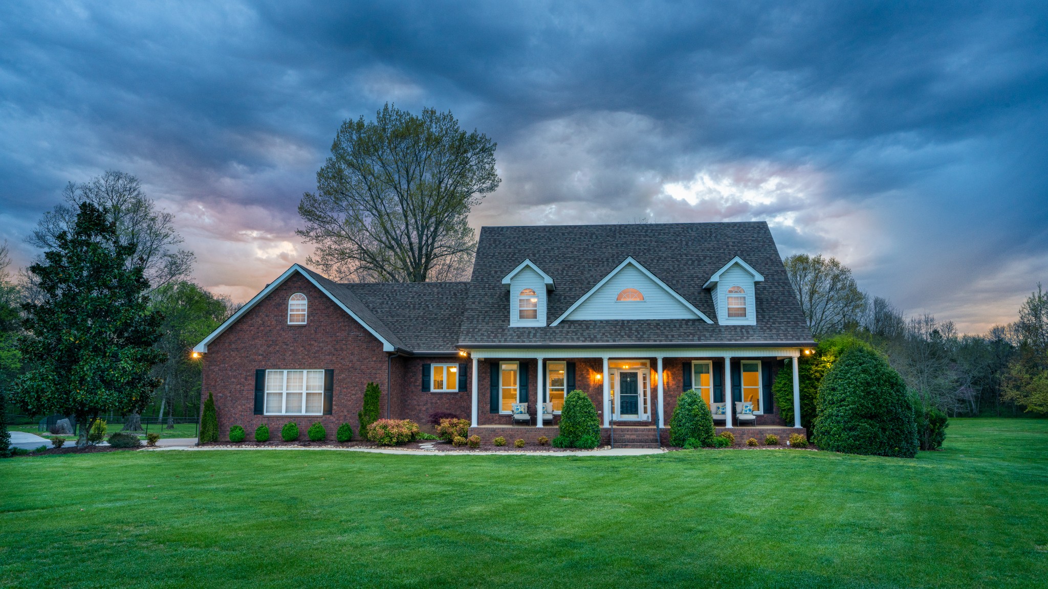 a front view of a house with a garden