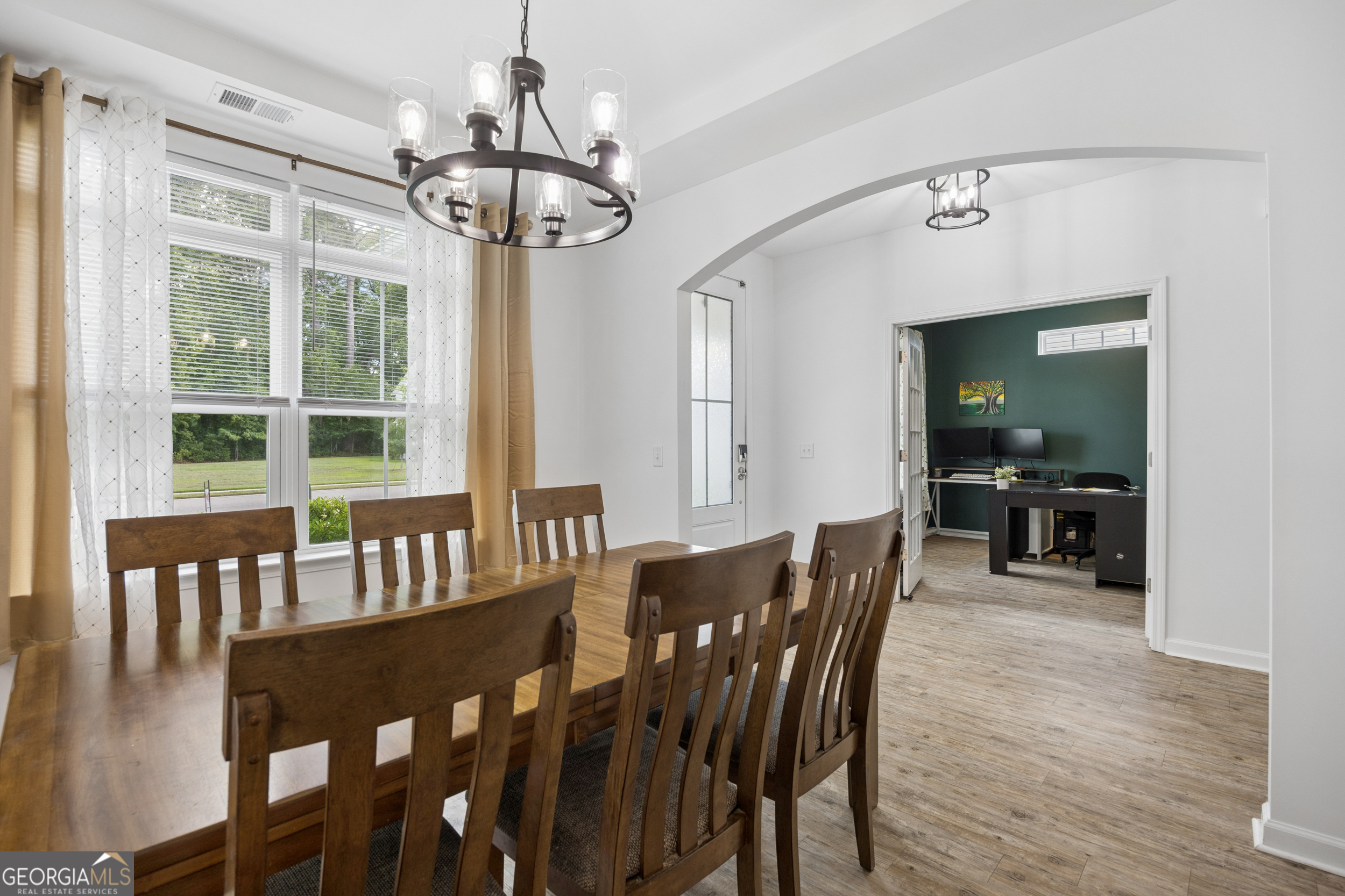 369 Waybridge Way Richmond Hill, GA 31324 - Photo 12 of 40 a view of a dining room with furniture wooden floor and chandelier