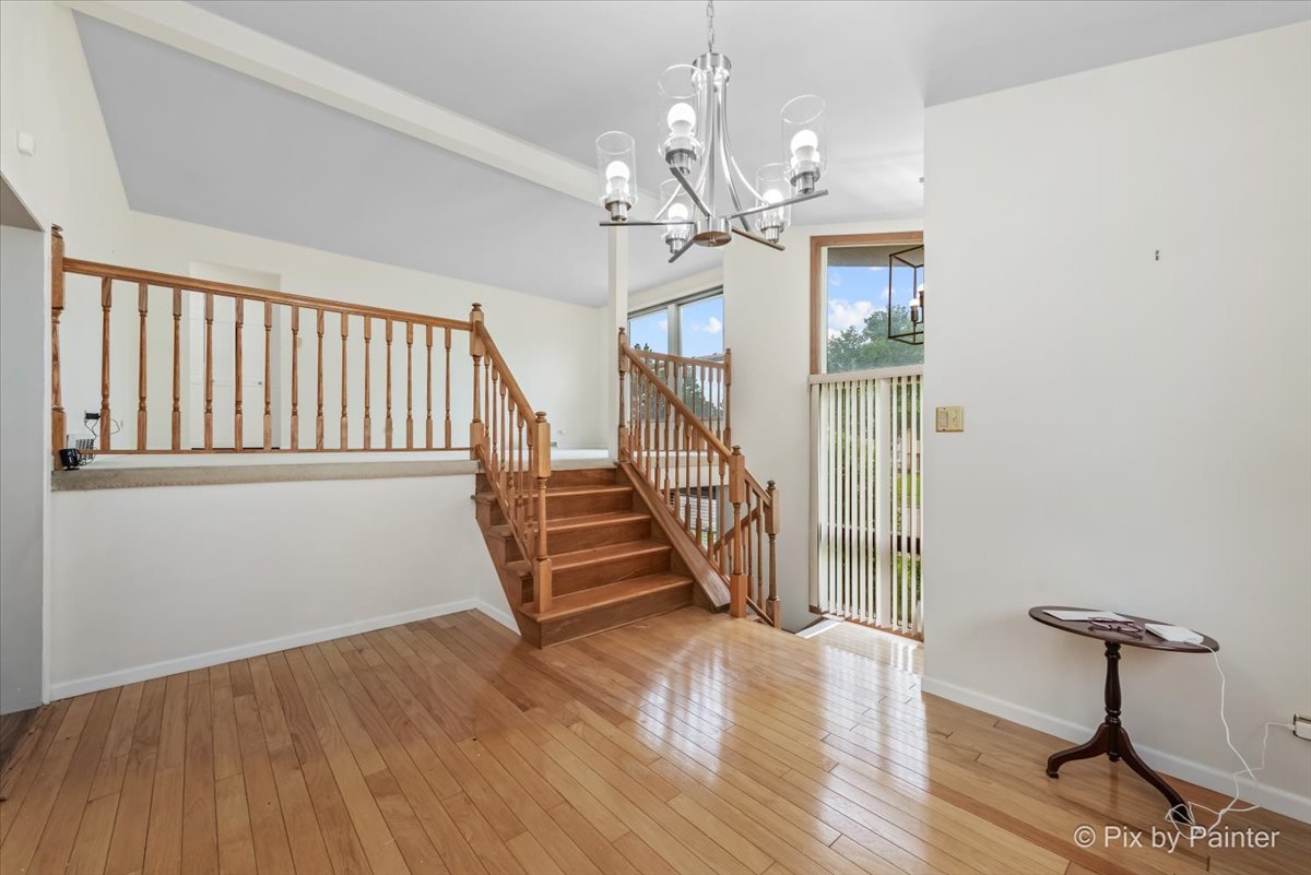 2302 Birch Lane Rolling Meadows, IL 60008 - Photo 2 of 30 a view of entryway with wooden floor and a chandelier