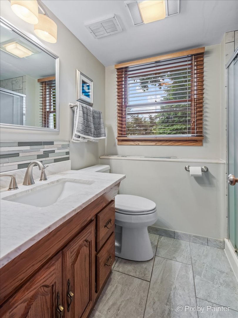 2302 Birch Lane Rolling Meadows, IL 60008 - Photo 22 of 30 a bathroom with a sink a toilet and a mirror