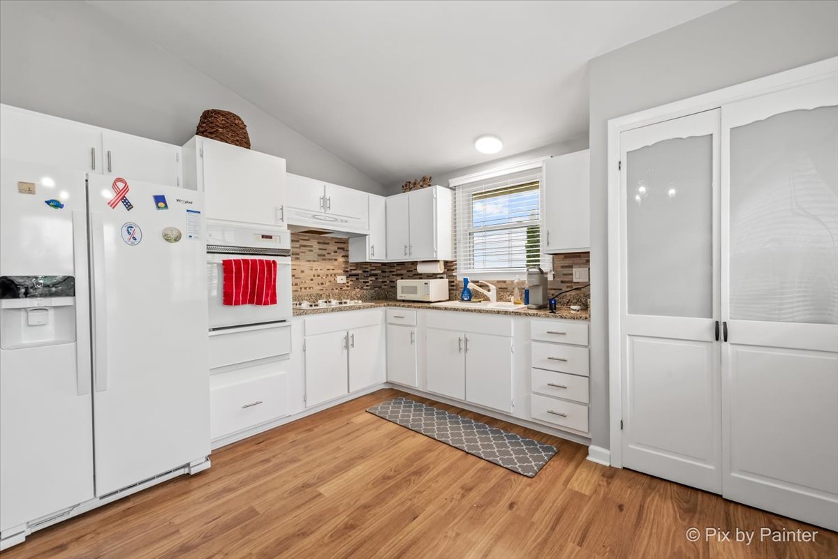 2302 Birch Lane Rolling Meadows, IL 60008 - Photo 3 of 30 a kitchen with granite countertop white cabinets and white appliances