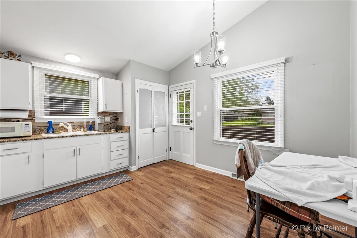 2302 Birch Lane Rolling Meadows, IL 60008 - Photo 4 of 30 a kitchen with a table chairs refrigerator and window